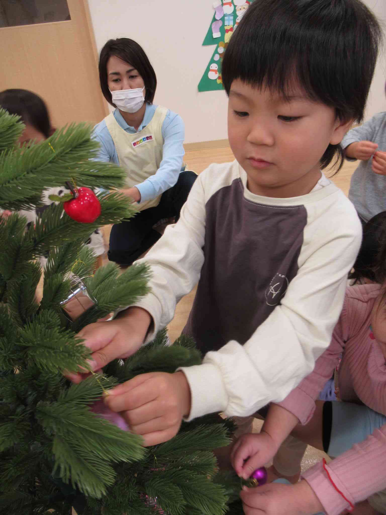 「こっちにかざったらいいよね～」「ここはどう？」とお友だちや保育士とお話しながら飾る場所を決める姿もみられました。素敵なツリーを完成させたい気持ちが伝わってきましたよ！